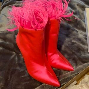 Pink heeled boots with feathers
